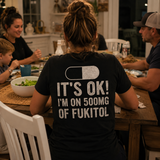 Woman wearing the black FUKITOL tee at a family dinner, back view