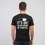 Man wearing the black FUKITOL tee, back view